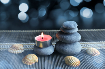 Zen pebbles with candle. Spa and healthcare concept.