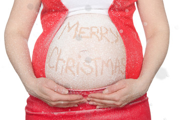 Belly of a pregnant woman with a Christmas greeting