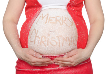 Pregnant woman's belly with Christmas text