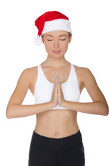 Beautiful asian woman in Santa's hat engaged in fitnes