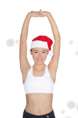 beautiful asian woman in Santa's hat engaged in fitness