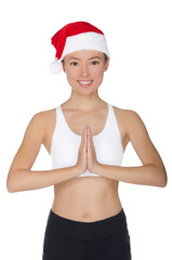 Smiling asian woman in Santa's hat engaged in fitness