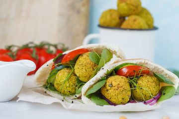 Baked falafel and fresh vegetables in pita bread. Vegan dietary healthy food concept.