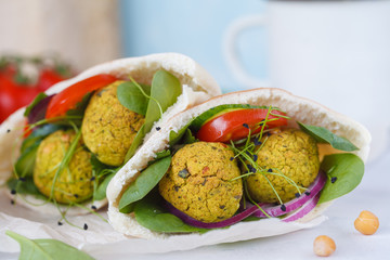 Baked falafel and fresh vegetables in pita bread, macro