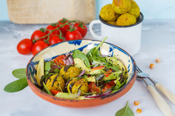 Falafel salad with fresh vegetables, sprouts and hemp dressing