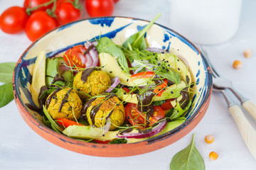 Falafel salad with fresh vegetables, sprouts and hemp dressing