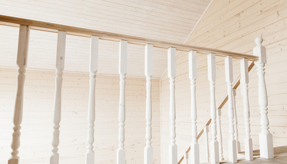 Balcony railings. Empty wooden house interior