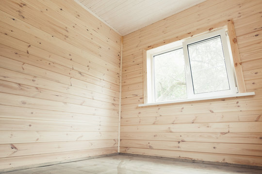 Empty interior, wooden walls and bright window