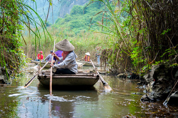Bamboo tourist boat in tam coc caves at Natural Reserve of Van Long wetlands. Van Long Lagoon is attractive eco tourism site for tourists in Gia Vien district Ninh Binh, Vietnam