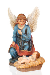 Fototapeta premium Ceramic figure of The Baby Jesus and the angel of the nativity scene