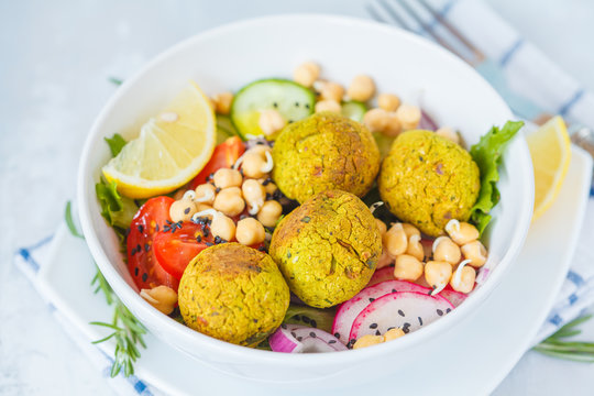 Baked falafel salad with vegetables and sprouted chickpeas