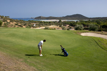 man playing golf on green course