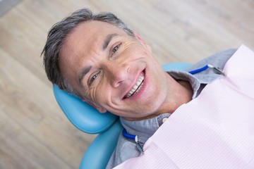 Overhead portrait of smiling man sitting on chair