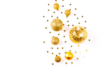 Christmas composition. a pattern of golden christmas balls and stars from above. Flat lay, top view