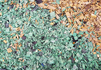 Decoration of the ground in the park with bright wooden chips
