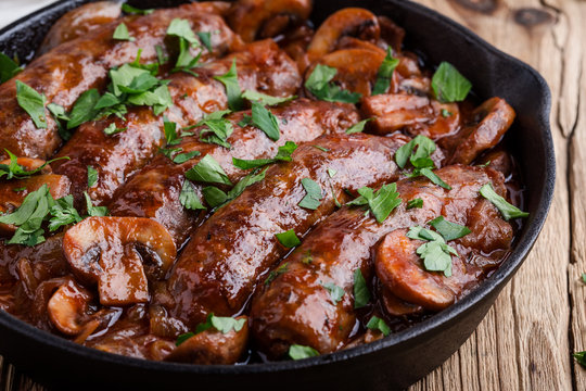 Sausages with onion and mushrooms gravy