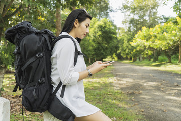 Asian woman using smartphone in park