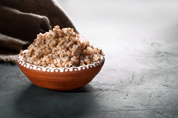 Buckwheat meal on dark background with place for text