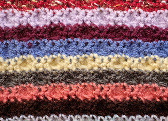 Horizontal stripes of coloured crochet stitches background