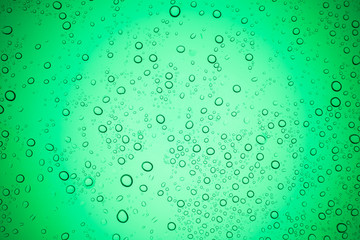 Rain droplets on green glass background, Water drops on glass.