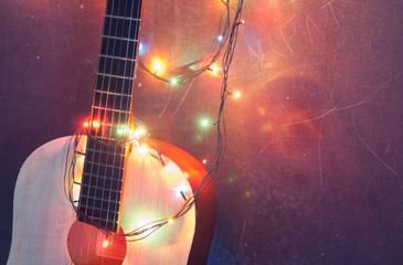 Christmas background, an acoustic guitar with a garland,