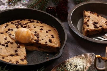 Close up of homemade Skillet chocolate chip cookie sliced, selectve focus