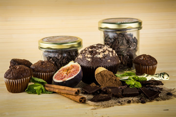 closeup  muffins, chocolate, figs, cinnamon, mint and cacao powder and raw cacao beans