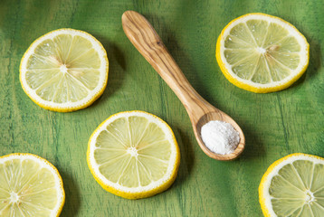 Lemon and baking soda on wooden table