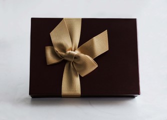 Terra cotta present box with gold ribbon