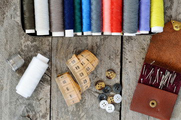 Spools of thread, measuring tape, sewing needles and buttons