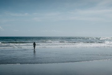 Fototapeta na wymiar Woman on sea. Beach holidays vacations at ocean. Film color toned filter