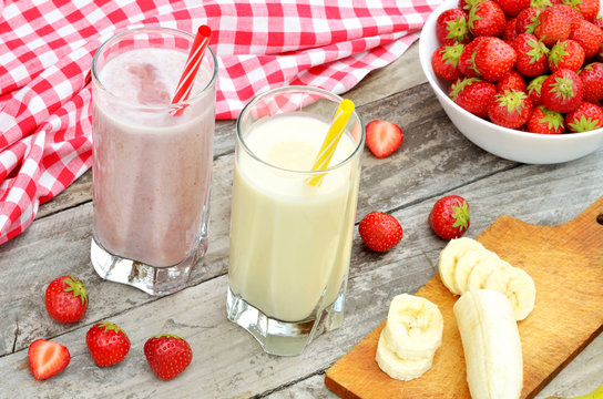 Strawberry and banana milkshake smoothie in the glass with straw