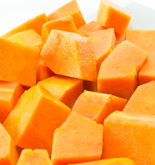 Sweet papaya in dish on white background