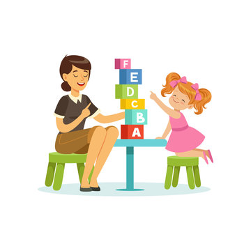 Cute little girl learning alphabet letters through play with speech therapist. Educational game concept