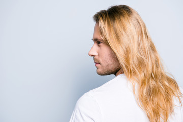 Close up half turned side view photo of young stylish handsome man with bristle and long clean...