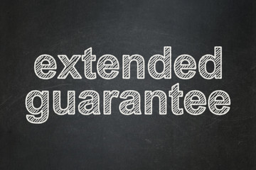 Obraz premium Insurance concept: text Extended Guarantee on Black chalkboard background