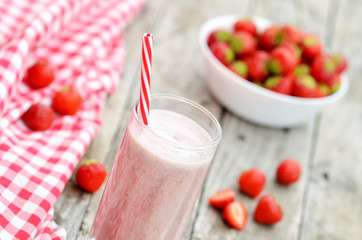 Strawberry milkshake smoothie in the glass with straw
