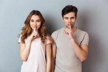 Portrait of a smiling couple showing peace gesture
