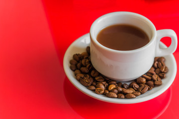 white coffee mug on a red background.  copy space