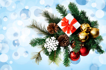 Christmas composition with fir tree, gift, cones, balls and snowflakes.