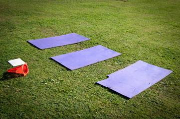 Three Fitness Mats on the Grass