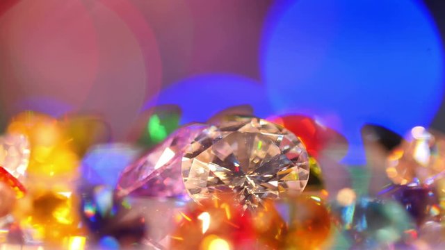 gemstones are showing on rotating platform. new year 2018 on the back of gemstones. bokeh of colorful christmas shine on the end.