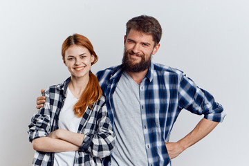 Beautiful young woman on a light background with a bearded man, relationship, friendship