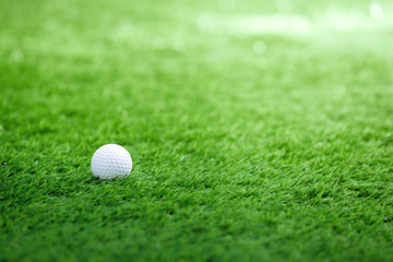 Golf ball on green grass in golf course