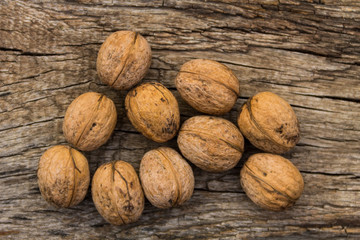 Walnuts on rustic old wooden table. Top view