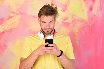 Musical lifestyle. Blue eyed stylish hipster with smartphone.