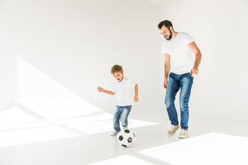 father and son with soccer ball