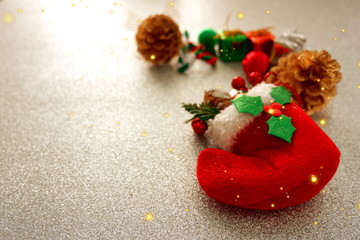 Christmas background with red sock,gift box,pine,candy on sparkling snow background ,top view for copy space