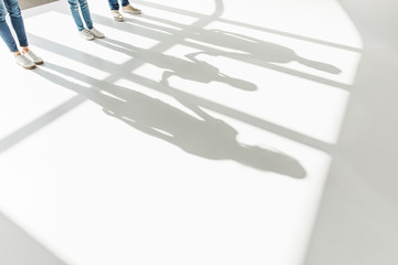 legs of family and shadows