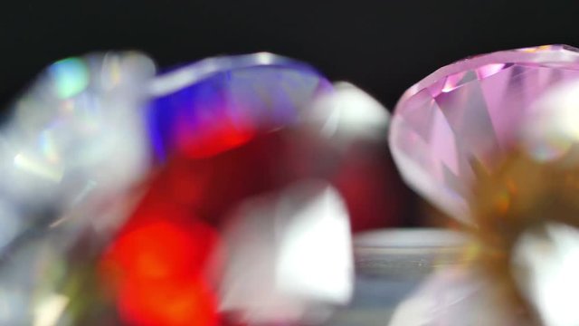 gemstones are showing on rotating platform. new year 2018 on the back of gemstones. bokeh of colorful christmas shine on the end.